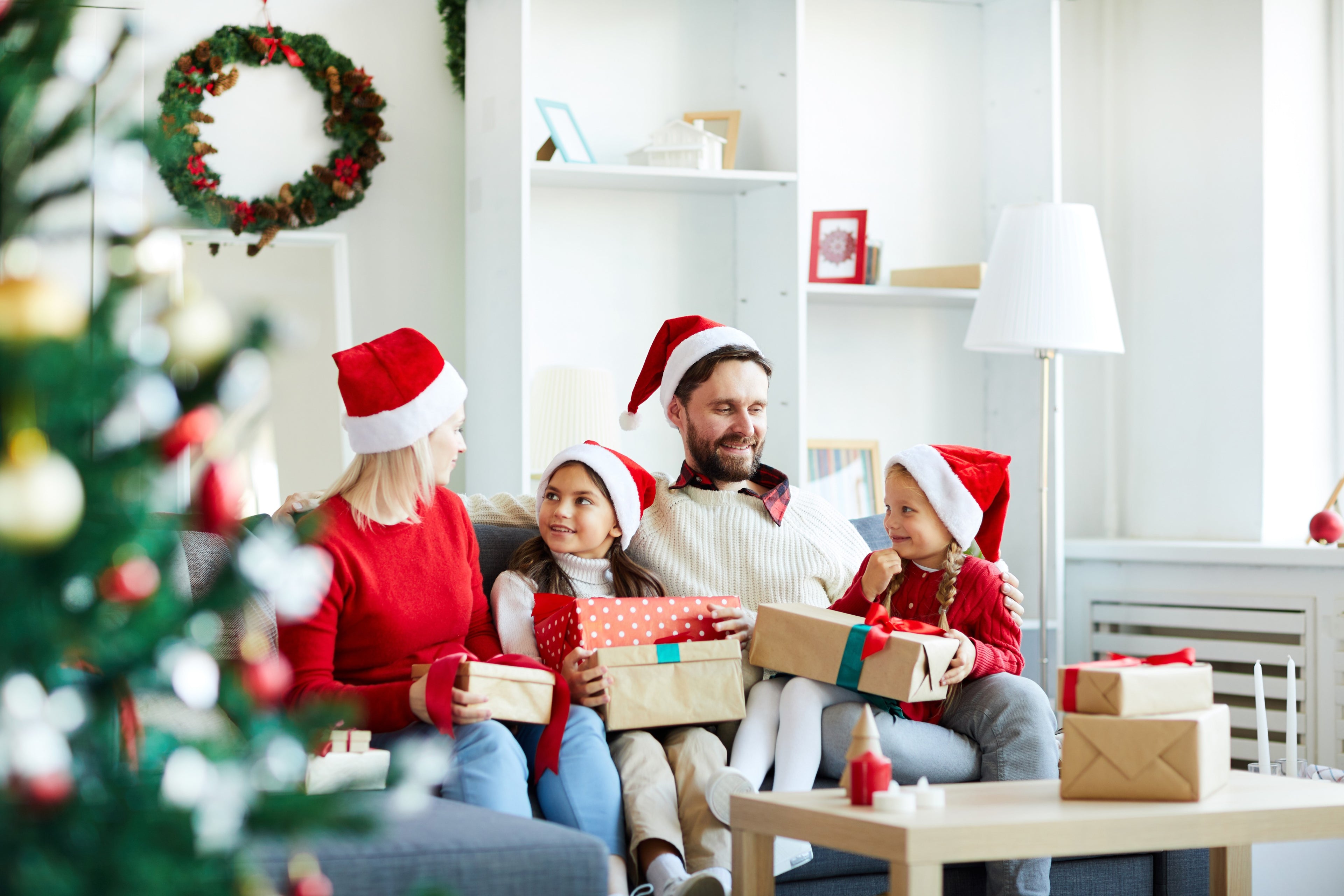 happy-family-sitting-sofa-unwrapping-christmas-presents (1).jpg__PID:a71d266a-7e0c-44e4-9e3c-09343f89f79c